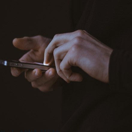 person interacting with smartphone touch screen