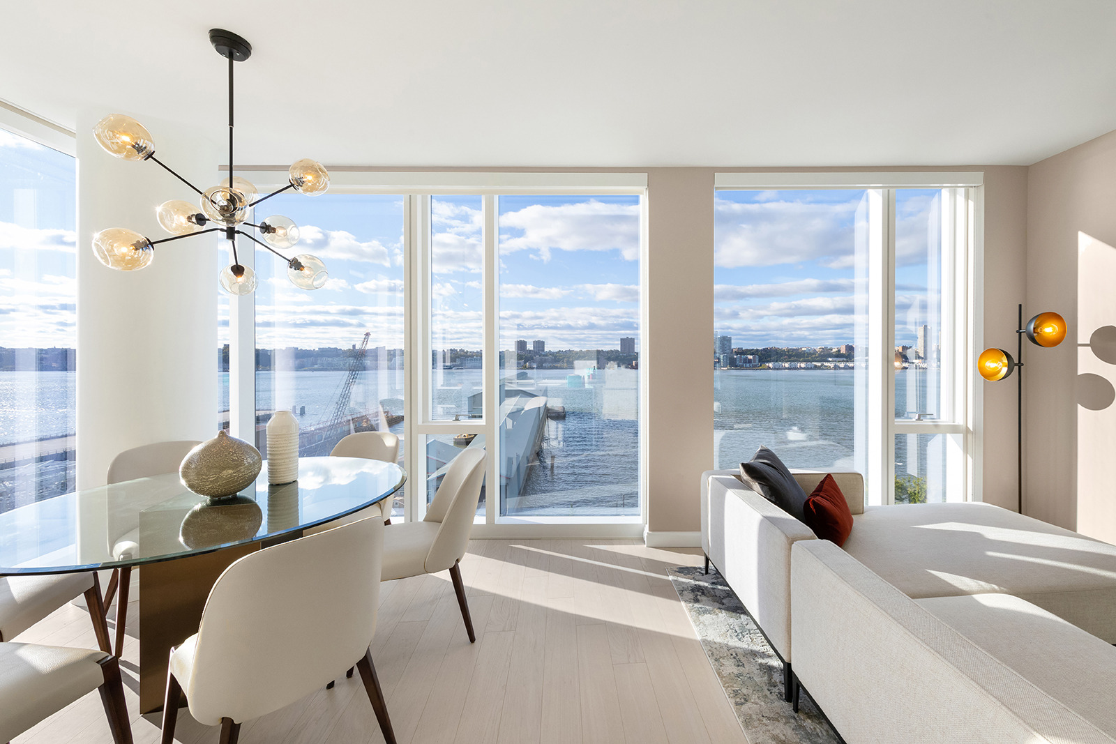 Bright and modern living space with expansive windows offering a panoramic view of the waterfront.