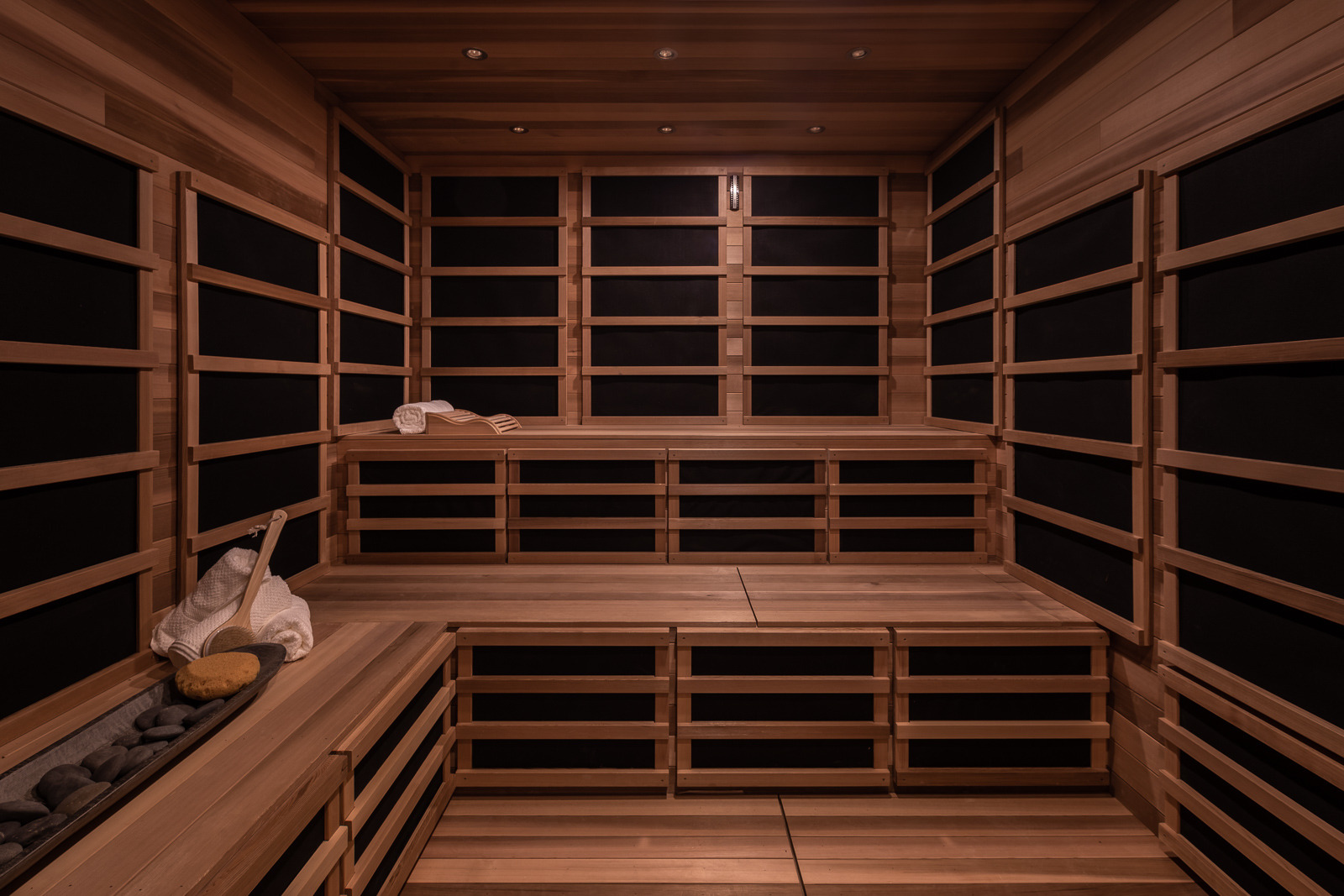 Wooden sauna interior with tiered empty seating, ready for a relaxing experience.