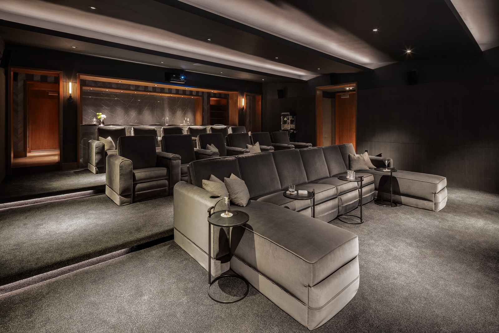 Luxurious home theater with plush seating and sophisticated interior design.